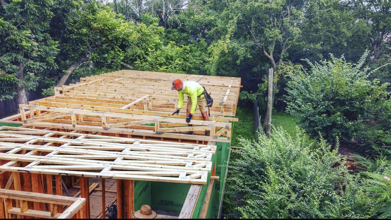 Open wood framing for a two story addition to an existing home.